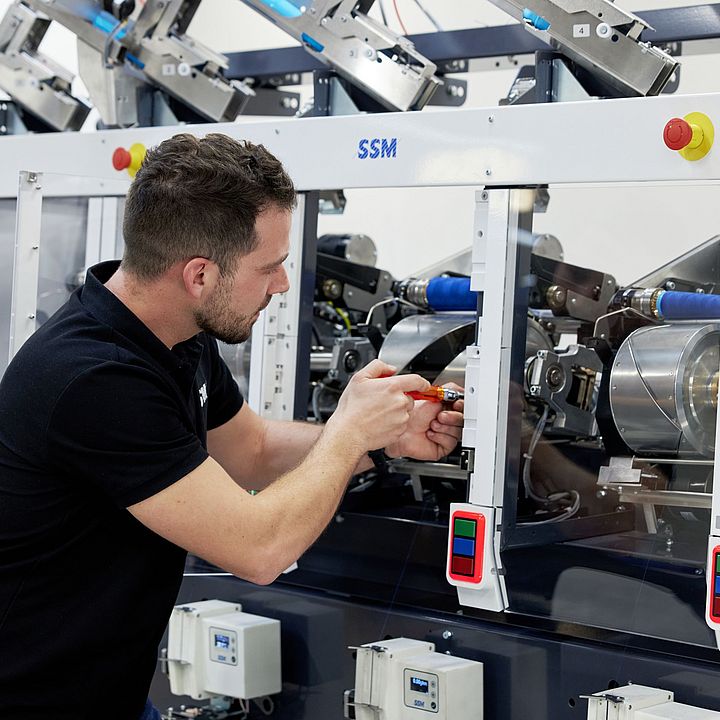 SSM specialist performing upgrades and retrofits on a winding machine to enhance efficiency and extend machine lifespan.