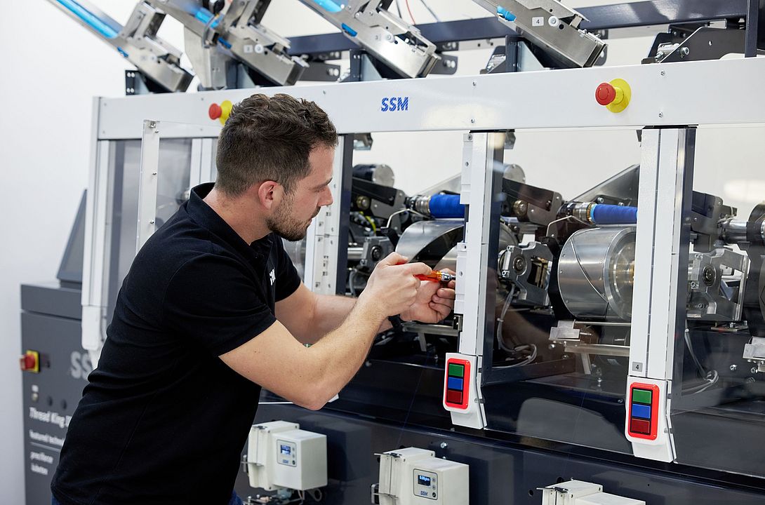 SSM specialist performing upgrades and retrofits on a winding machine to enhance efficiency and extend machine lifespan.