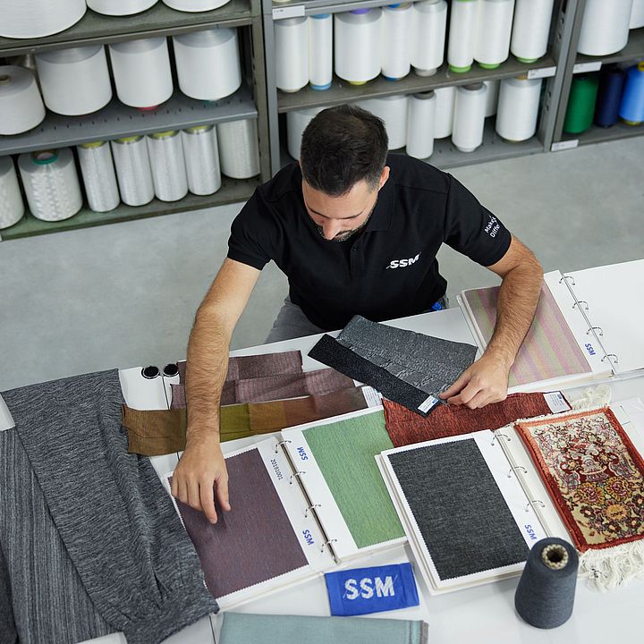 SSM textile technologist assessing yarn to provide quality recommendations to customers.