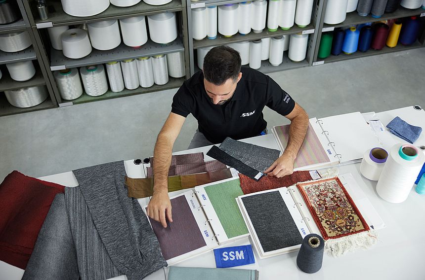 SSM textile technologist assessing yarn to provide quality recommendations to customers.