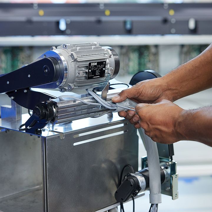 Technician preparing a motor for assembly on SSM winding machines