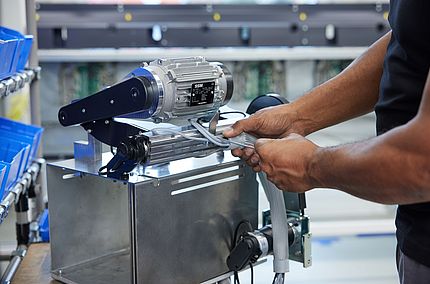 Technician preparing a motor for assembly on SSM winding machines